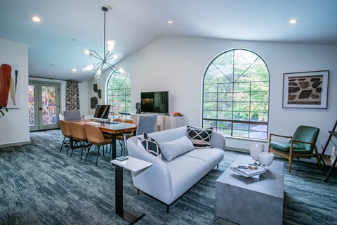 a living room and dining room with a couch and a table